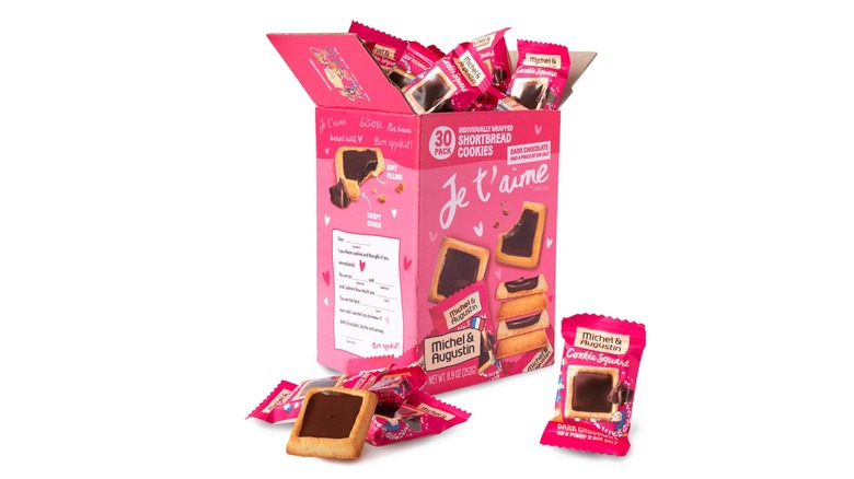 A pink box of Michel et Augustin chocolate cookie squares