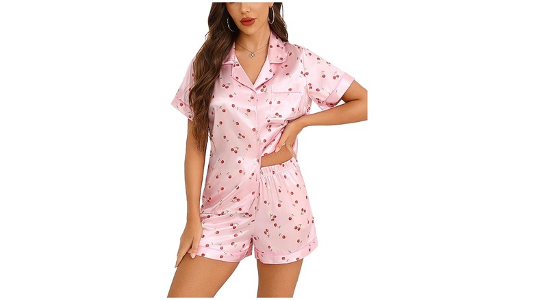 A person wearing pink cherry silk pajamas