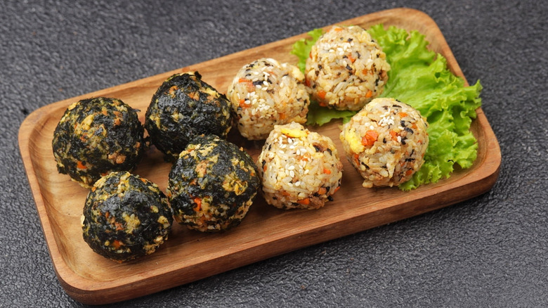 closeup of rice balls on wooden plate