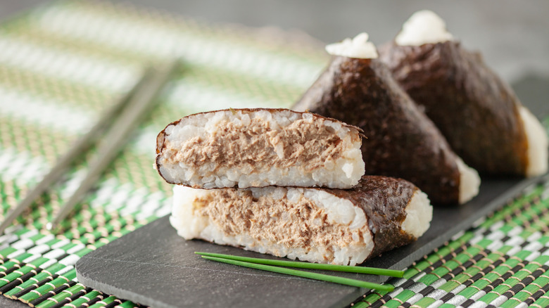 cross section of triangle kimbap on stone plate and green place settling