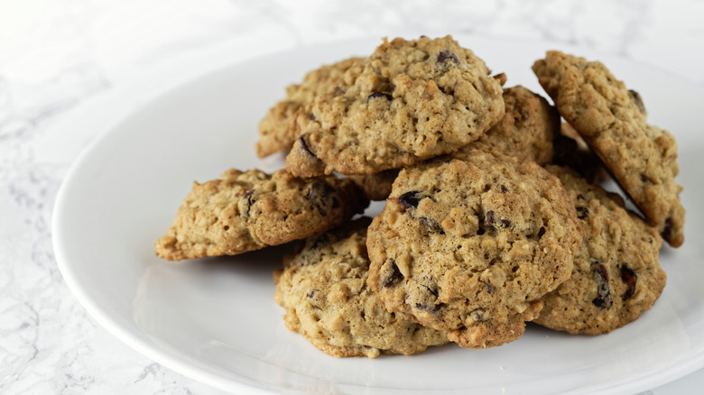 Baked oatmeal and raisin cookies on white plate