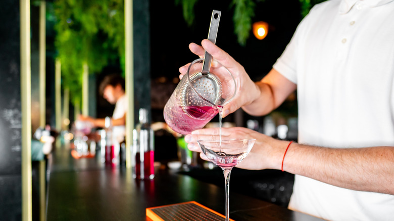 Bartender pouring a cocktail