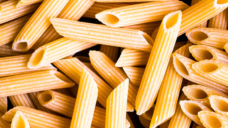 Close-up of dry penne noodles