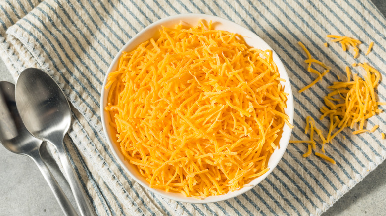 Bowl of shredded cheddar cheese