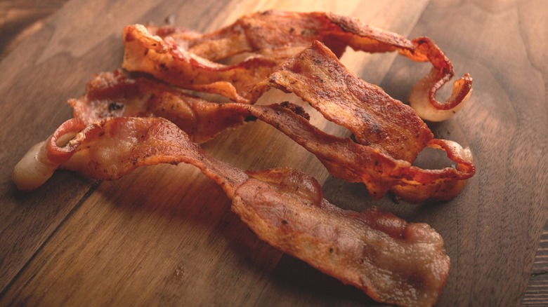 Bacon on wooden chopping board