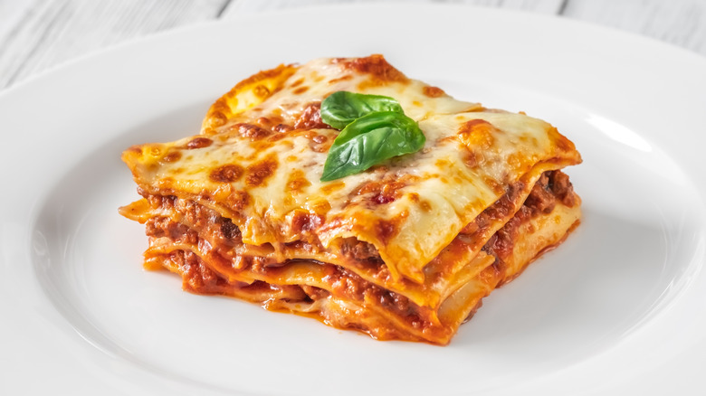 Plate of lasagna with basil on top