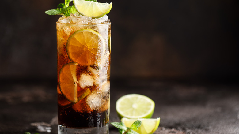 Cuba Libre with mint garnish and cut limes