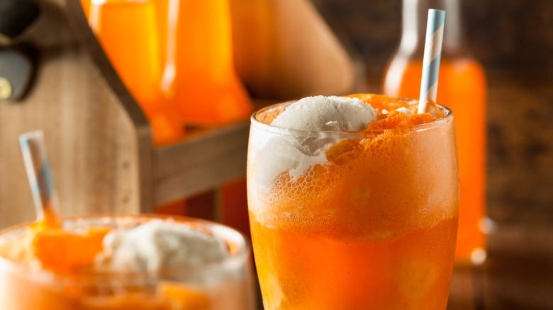 orange creamsicle cocktails with bottles of orange soda