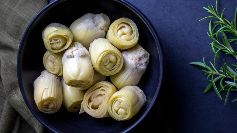 marinated artichoke hearts in a black bowl