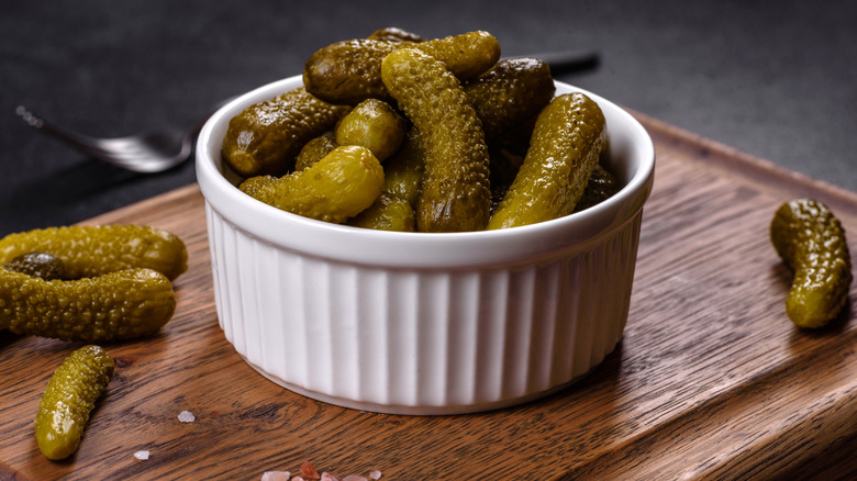 cornichons in a fluted white bowl