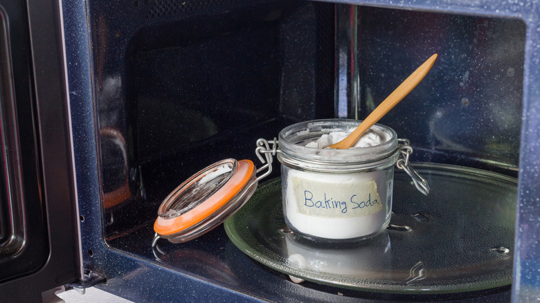 jar of baking soda inside a microwave