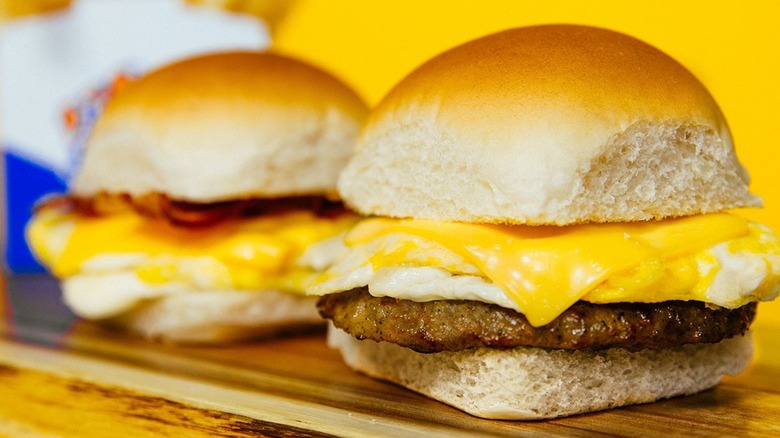 Two White Castle egg sandwiches on wooden platter