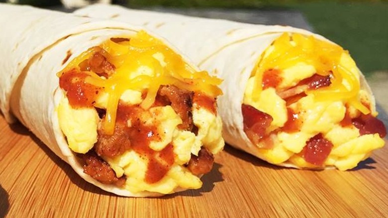 Del Taco breakfast burritos on a wooden table