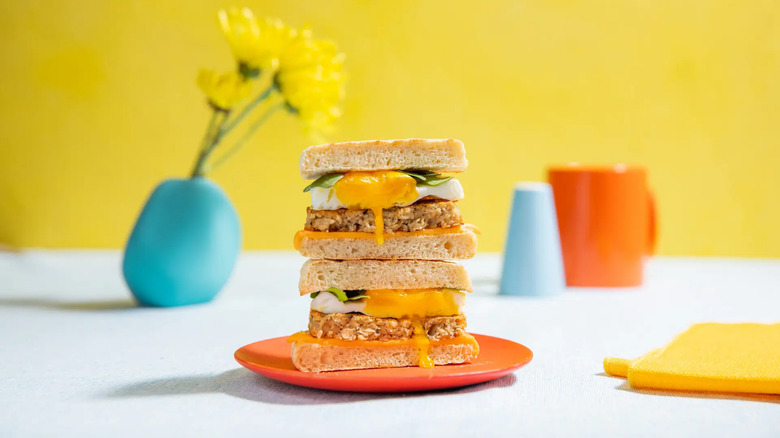 Egg and chicken sandwich against yellow background