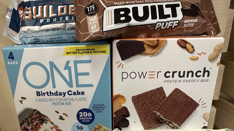 Varieties of protein bars in boxes and individuals on display