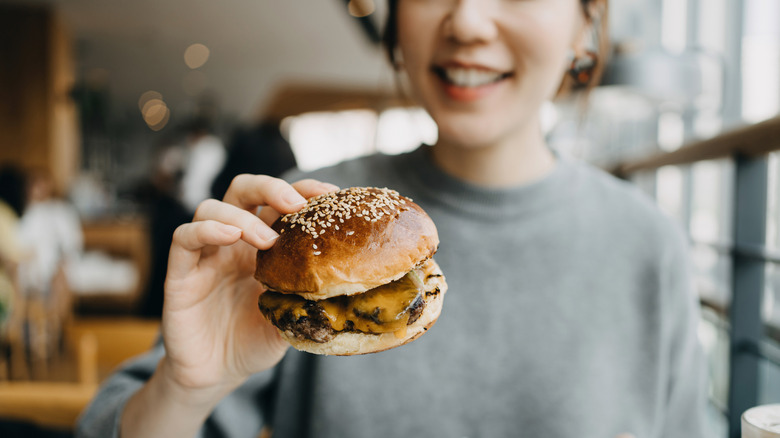 Person holding burger