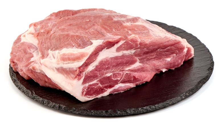 Boneless pork shoulder on white background