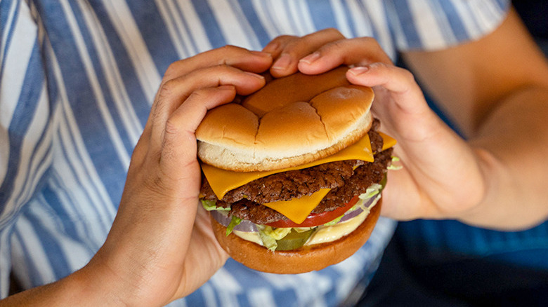 woman holding Culver's burger