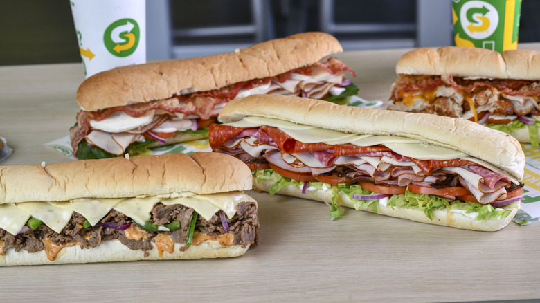 Different Subway sandwiches on table