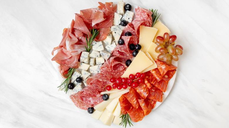 Charcuterie board with cheese, meat, and fruit