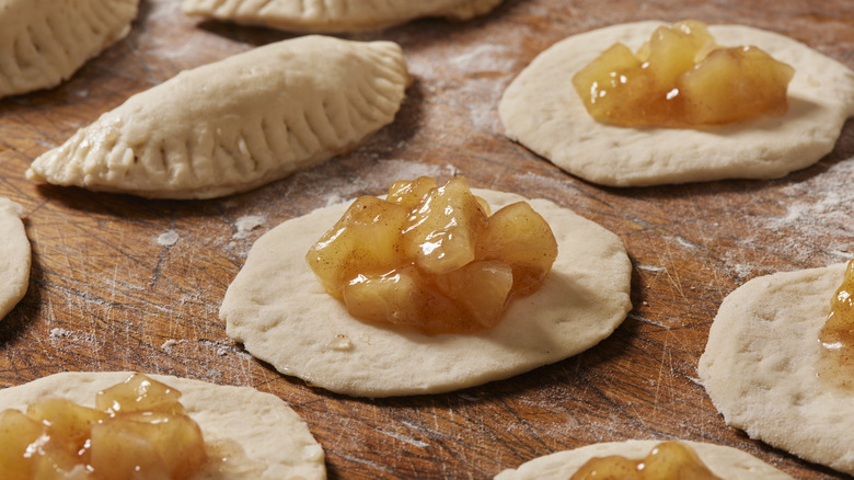 Apples sitting on pie dough