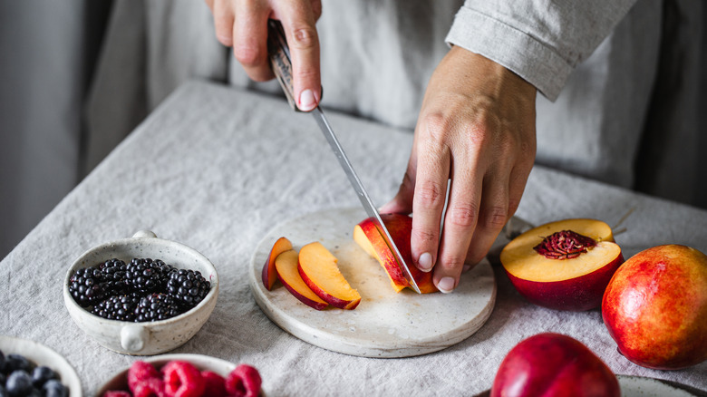 Person chopping fruit