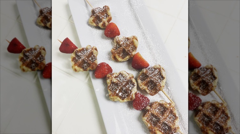 Waffle kebab with strawberries and powdered sugar