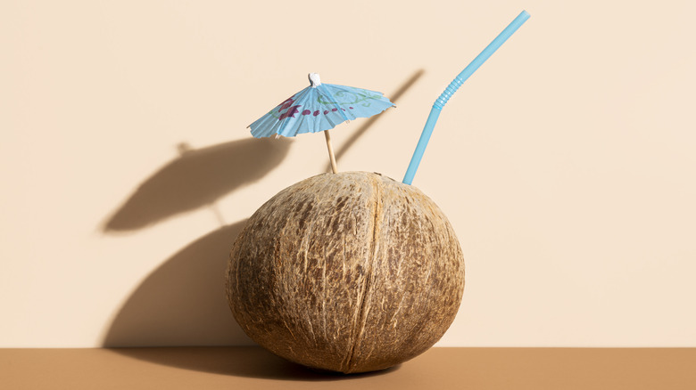 Coconut with umbrella and straw