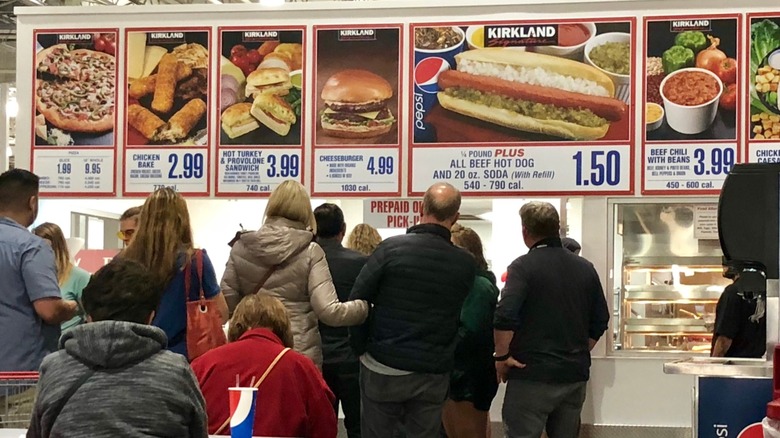 Patrons stand in line to order at Costco food court.