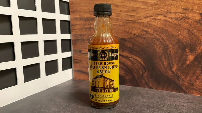 Bottle of Peter Luger Steak Sauce on grey counter