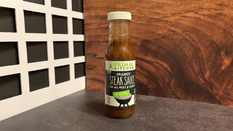 Bottle of Primal Kitchen Organic Steak Sauce on grey counter