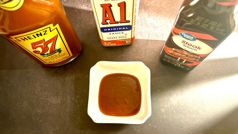 aerial view of steak sauce bottles with steak sauce in white ramekin