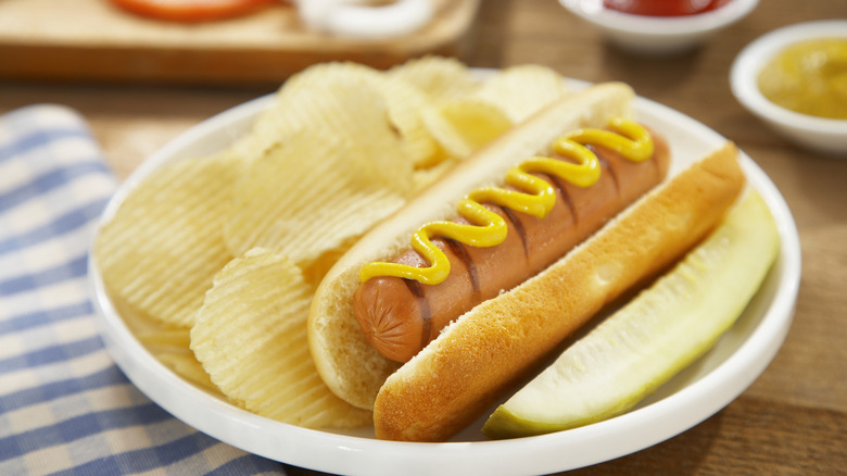 hot dog with mustard on a plate