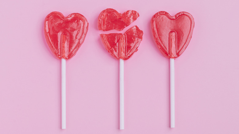 Valentine's red heart lollipops with one broken