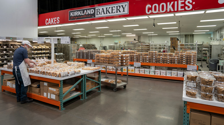 A worker stocks Costco's bakery selection