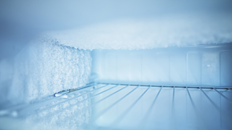 An interior shot of an empty freezer with frost on the walls