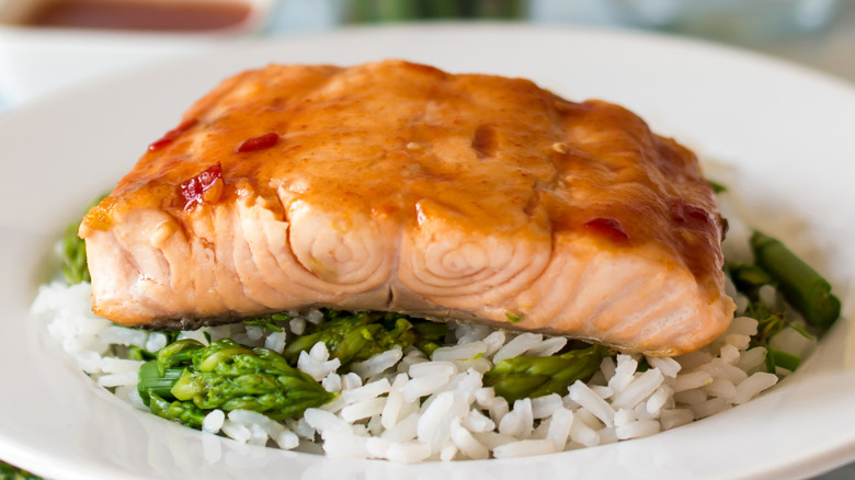 A salmon fillet on a bed of cooked rice