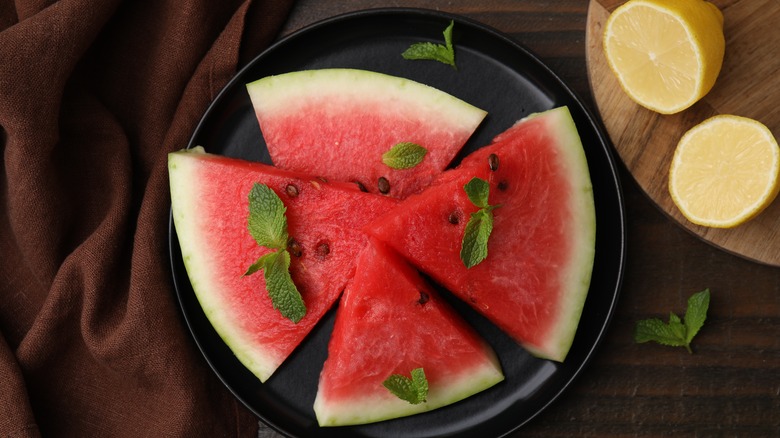 watermelon sliced up with lemon halves