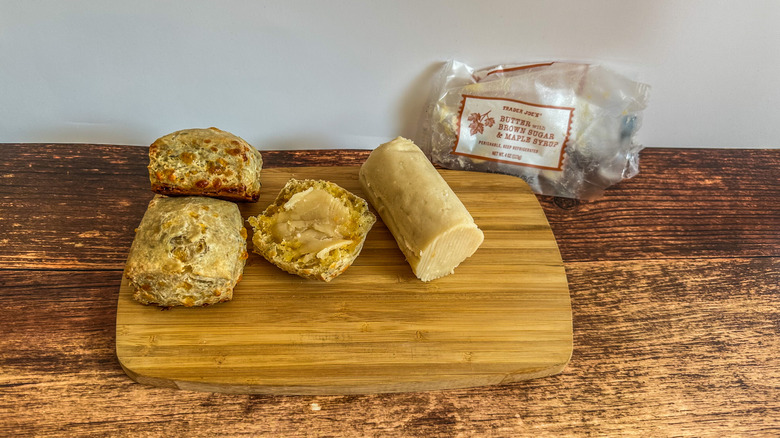 butter with brown sugar and maple syrup spread on a cheesy biscuit