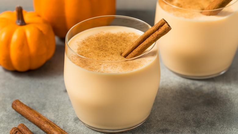 glass of eggnog with pumpkin pie spice sprinkled on it