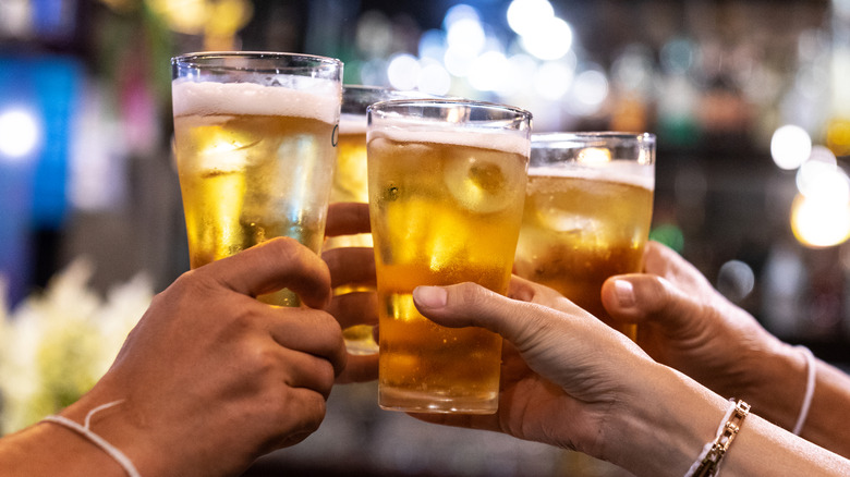 Friends toasting with cold pints of beer