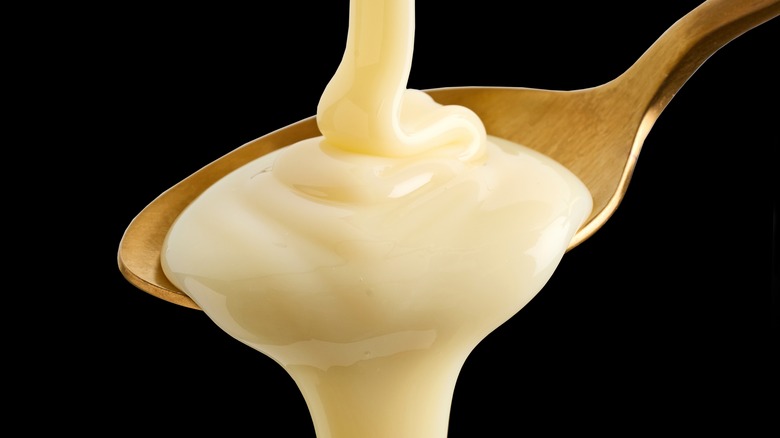 Condensed milk drizzled onto a spoon