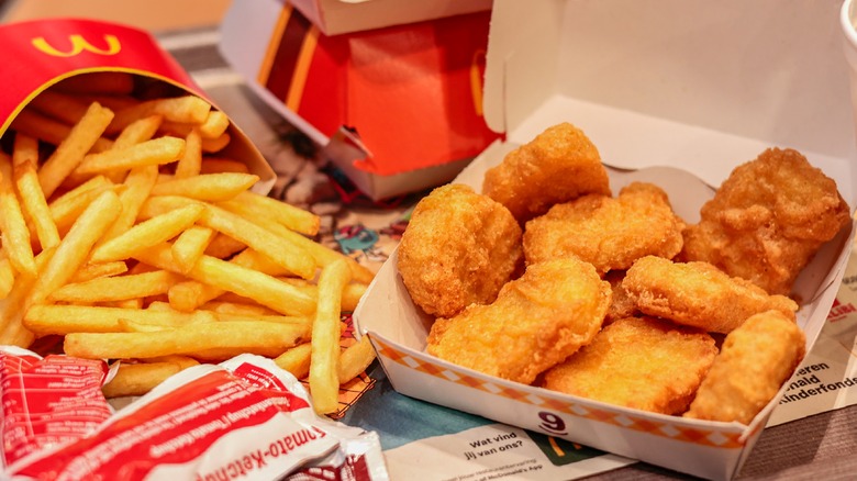 McDonald's fries, chicken nuggets, and closed burger boxes with ketchup packets