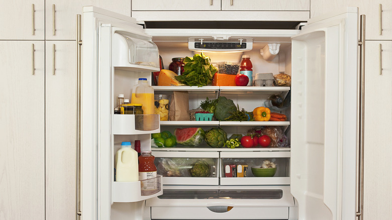 A fridge with open doors and healthy food inside