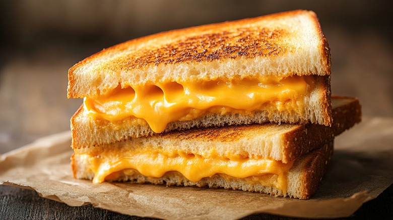 A close up of stacked grilled cheese sandwiches on a plate