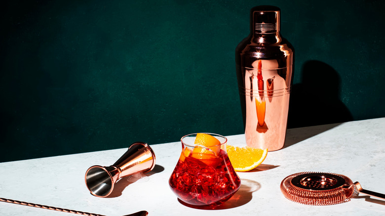 boulevardier cocktail with bartending equipment on table