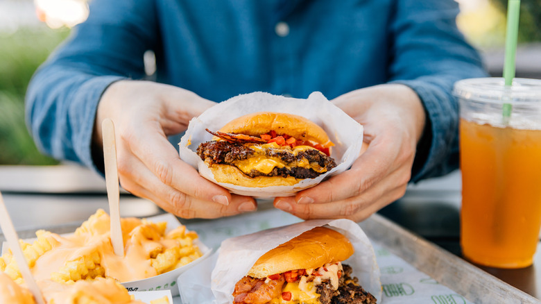 Person holding a burger