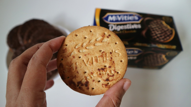 person holding digestive biscuit