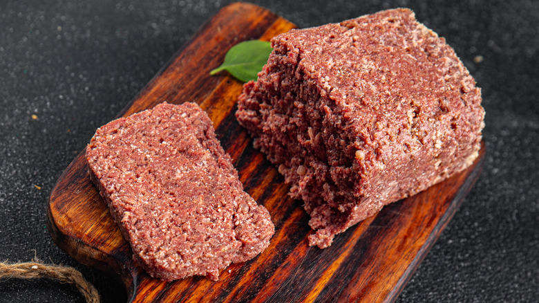 Spam meat from a can on a cutting board