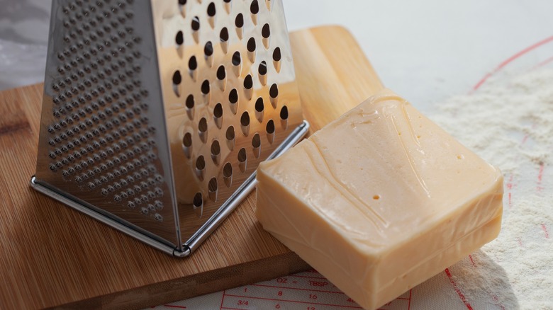 box cheese grater and block of cheese